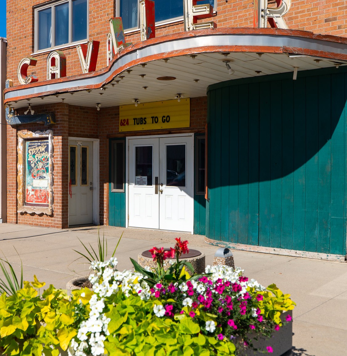 small town theater with flowers in the front