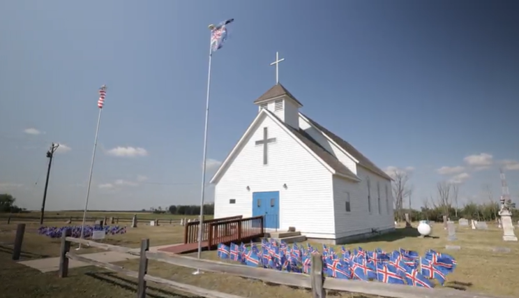 rural church with Icelandic flags